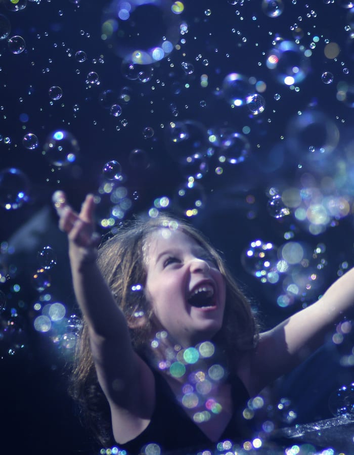 Iridescent bubbles floating in the dark